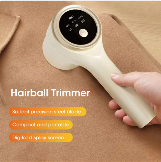 Hairball trimmer held by a hand on a brown fabric background with text highlighting features.